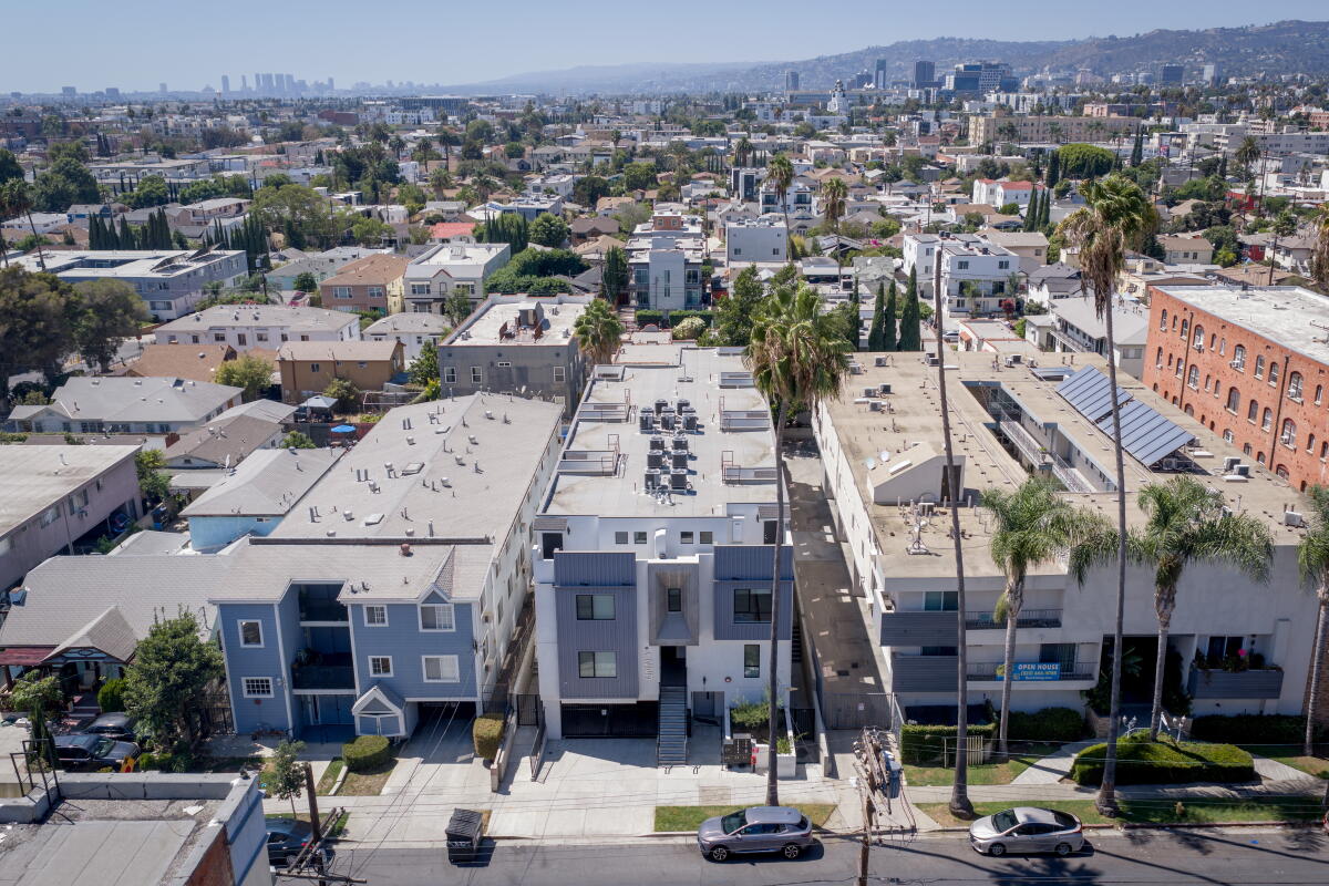 A row of buildings on a street in a crowded area 