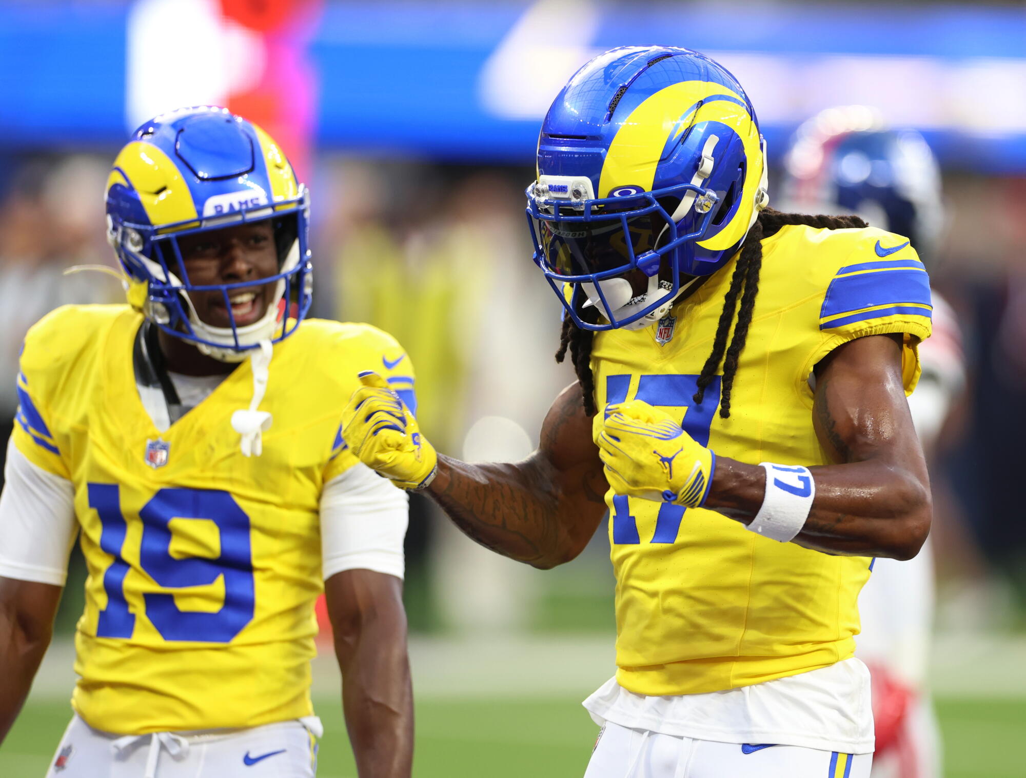 Rams wide receiver Davante Adams, right, celebrates with wide receiver Xavier Smith after catching a touchdown pass.