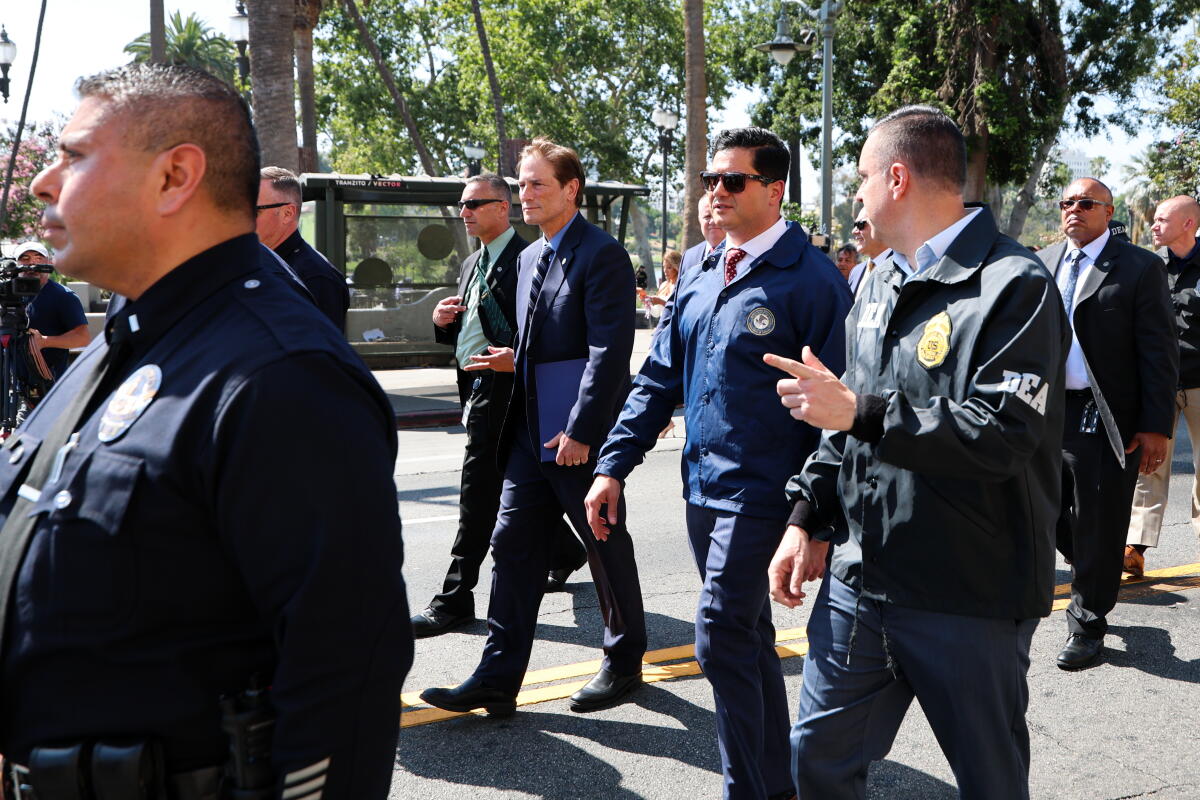 Los Angeles District Attorney Nathan Hochman walks during a raid at MacArthur Park in June.