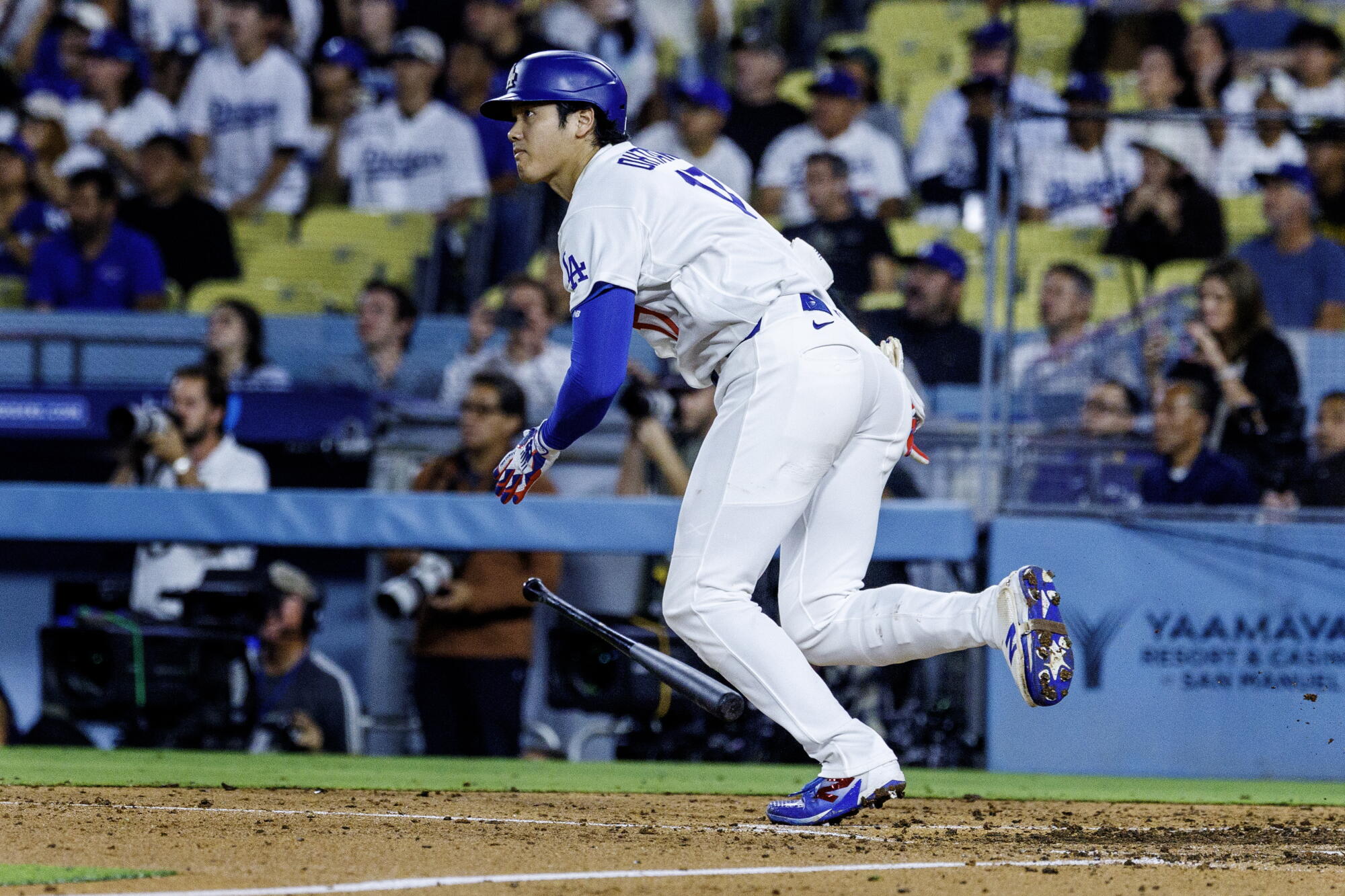 Dodgers star Shohei Ohtani hits a run-scoring double in the ninth inning against the Padres on Thursday night.