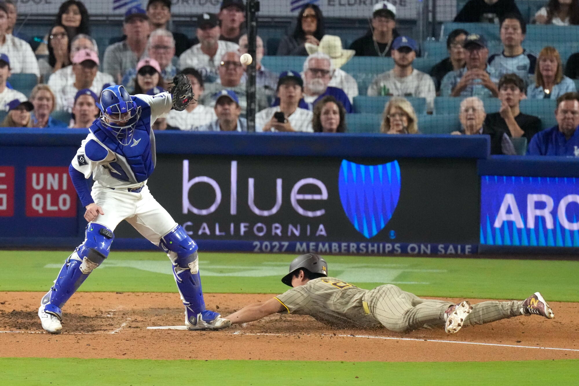 San Diego's Sung-mun Song, right, scores past Dodgers catcher Hunter Feduccia.