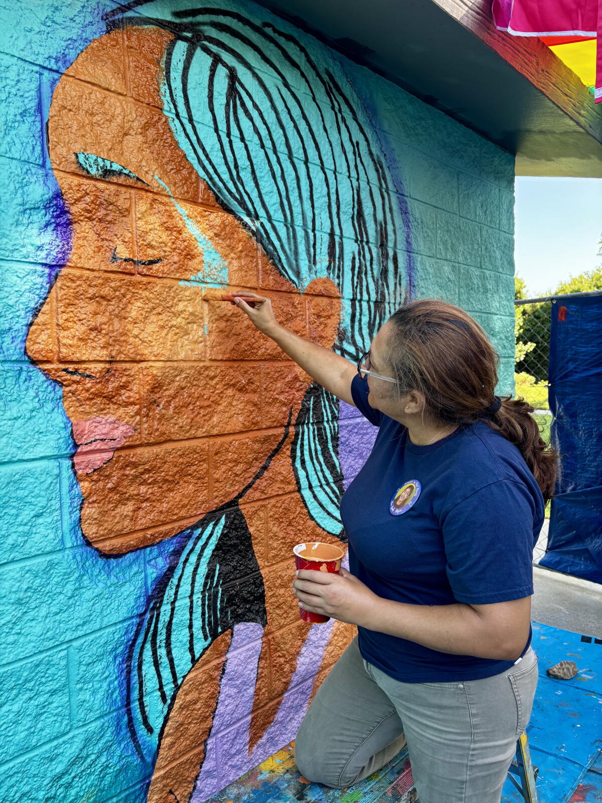 Veronica Mejia paints an image of her daughter, Mia, who lost her life to suicide last year.