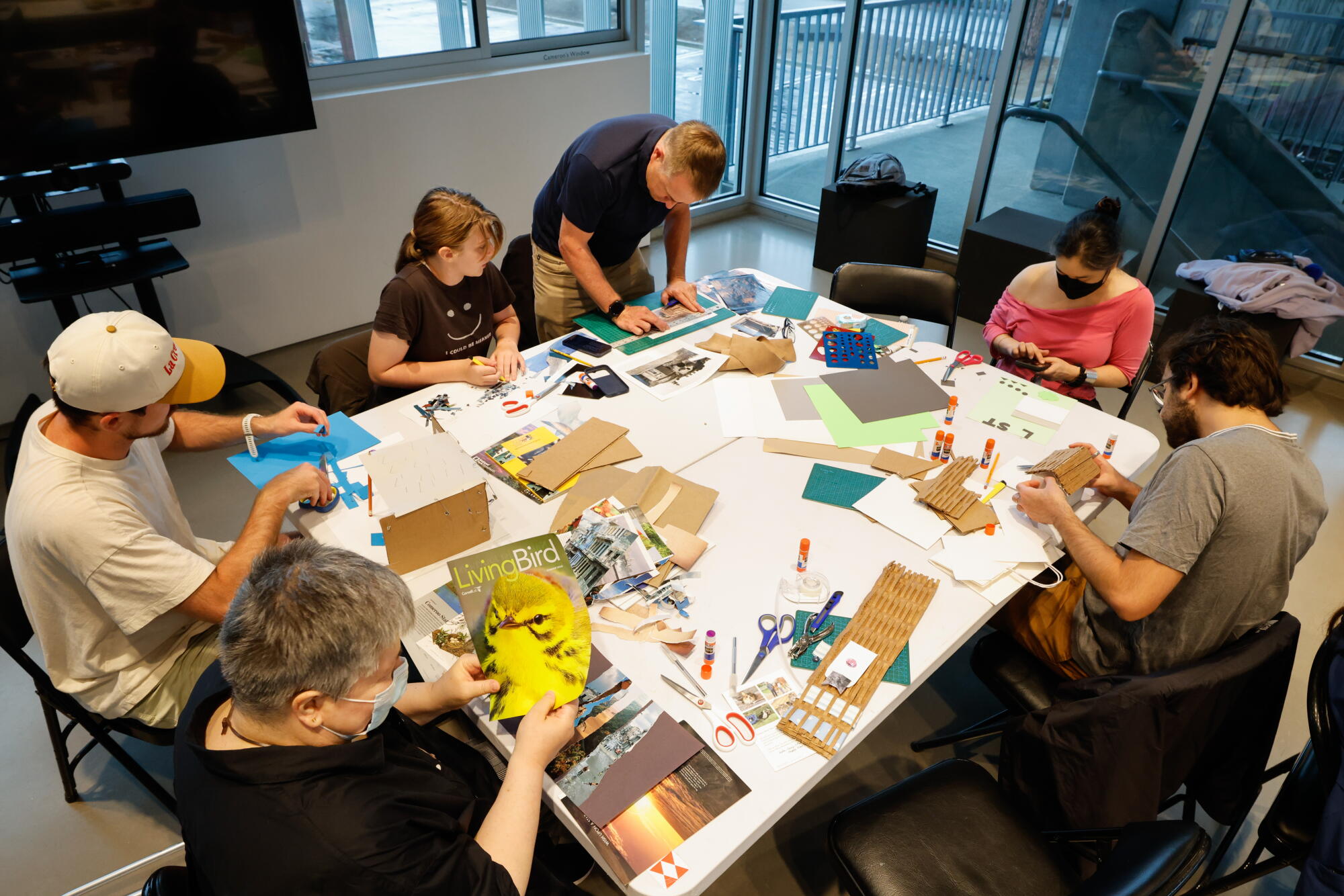 A group works on art projects around a table.