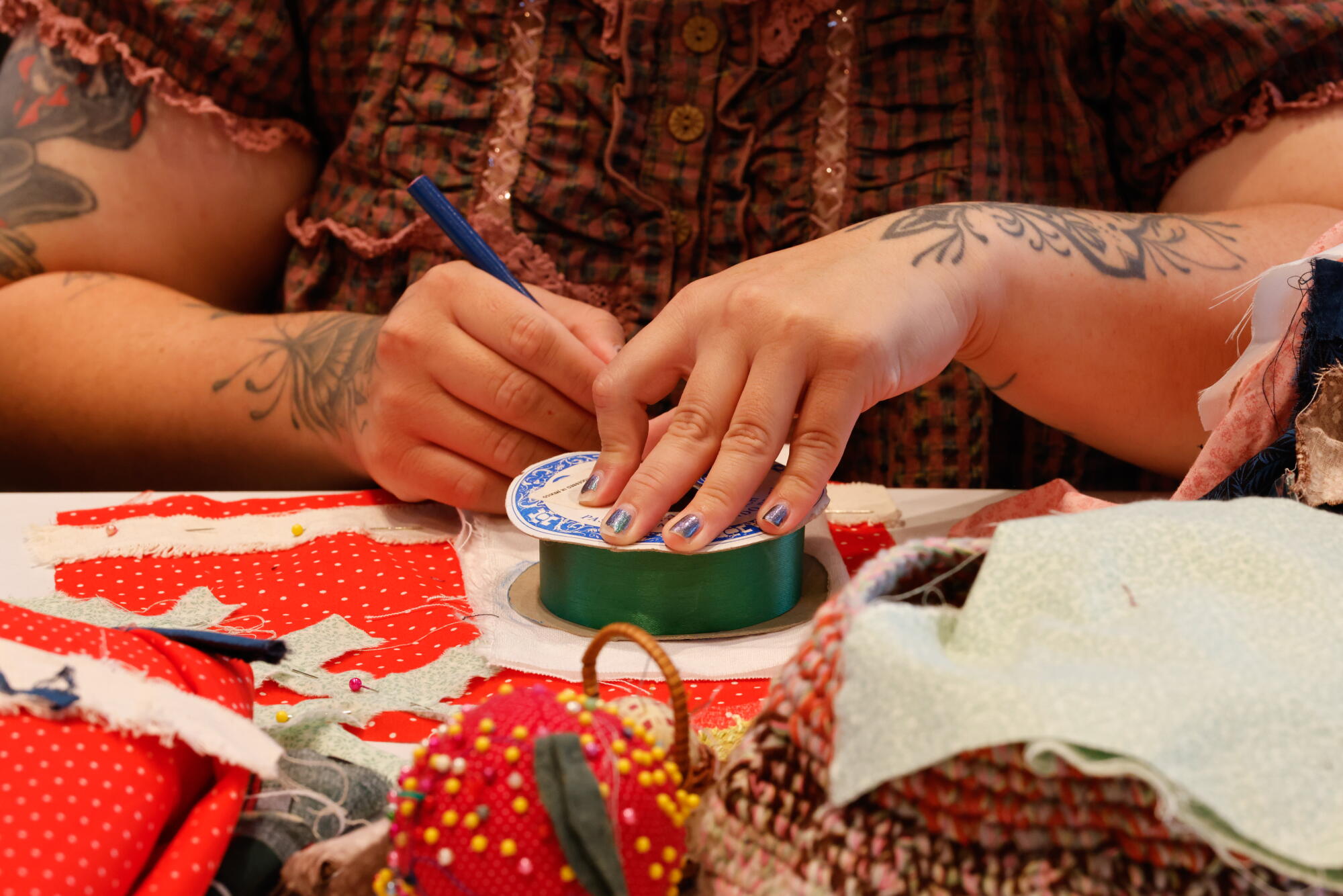 A woman's hands as she works on an art project.