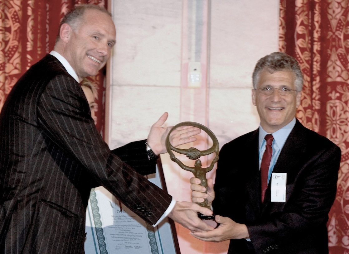 man receiving an award in a suit