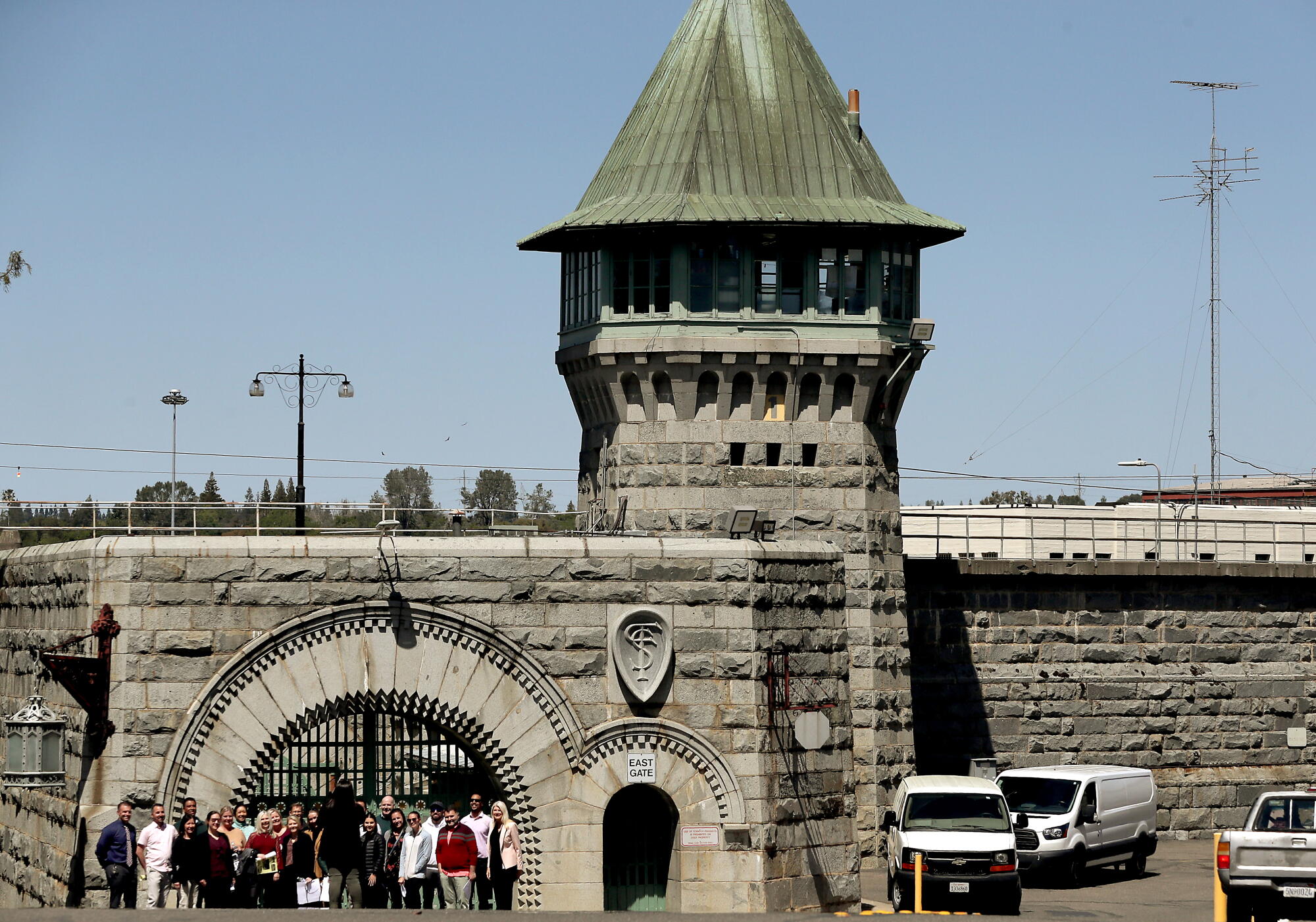 Represa CA - April 13: A tour group gathers for a group photo at the iconic entrance of Folsom Prison. 