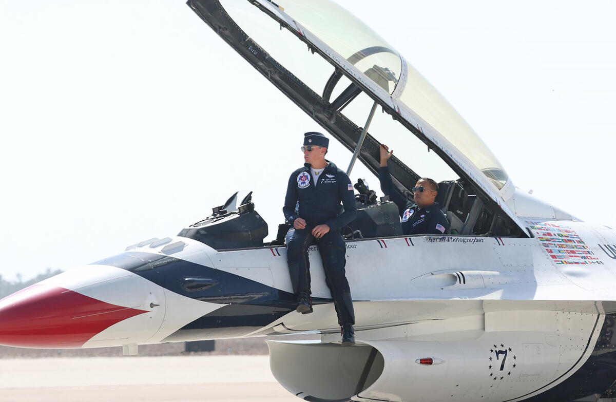 Lt. Col. Tyler Keener sits on the cockpit in his F-16 Fighting Falcon in Los Alamitos on Tuesday.
