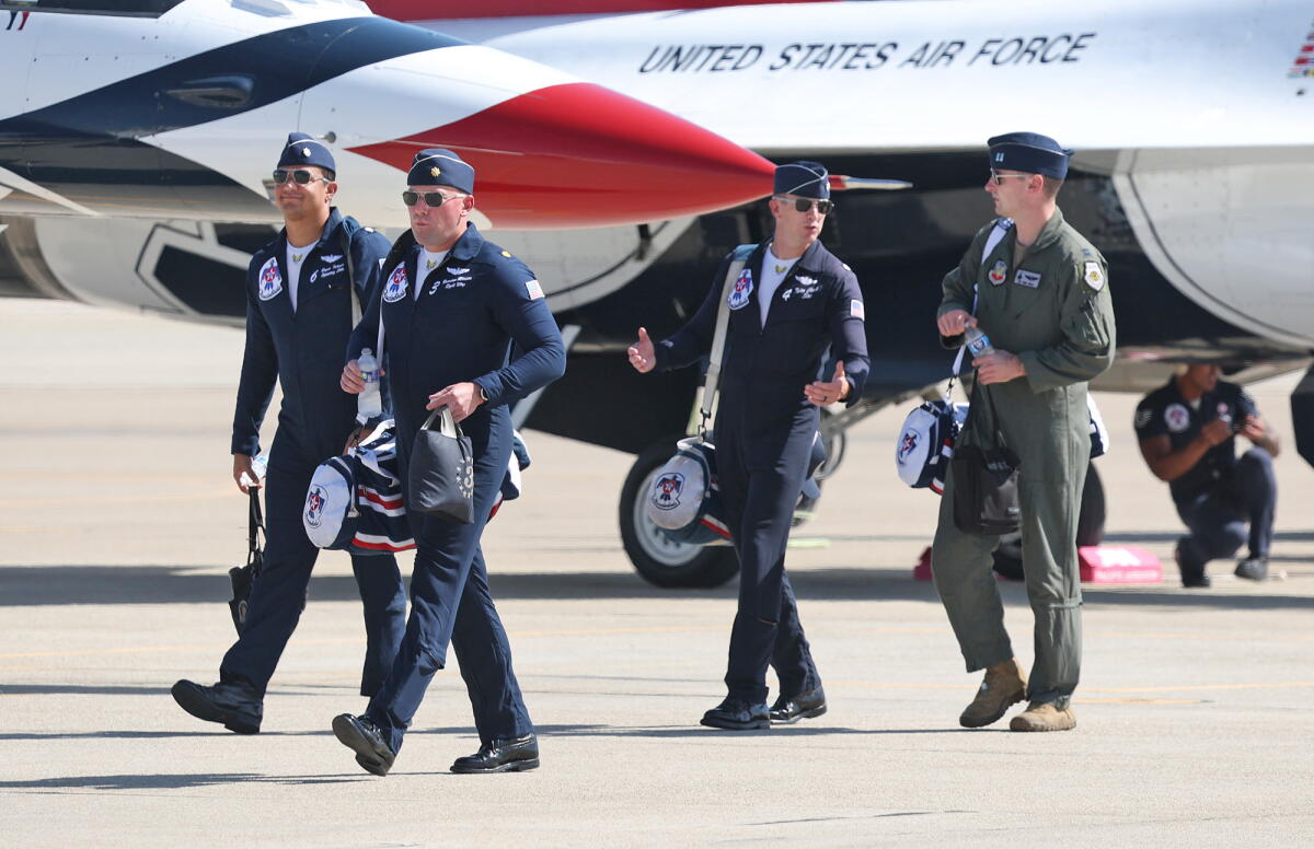 Crews from the U.S. Air Force Thunderbirds gather near their F-16 Fighting Falcons in advance of the Pacific Airshow.