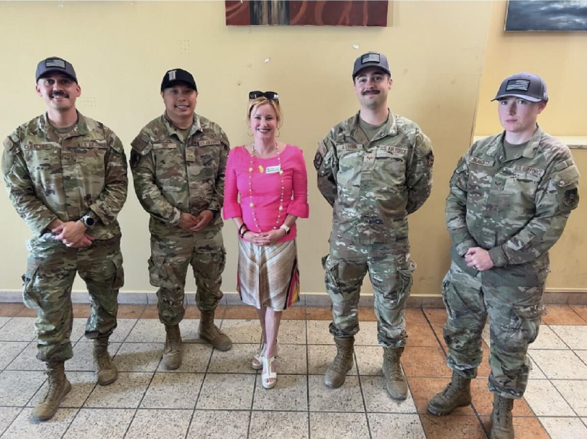 Anaheim Mayor Ashleigh Aitken poses with members of the U.S. armed forces in Doha, Qatar.