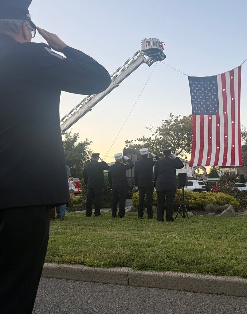 Members of the Long Beach Fire Department conducted a fire department flag arch, a ceremonial display, to honor those who died on Sept. 11, 2001.