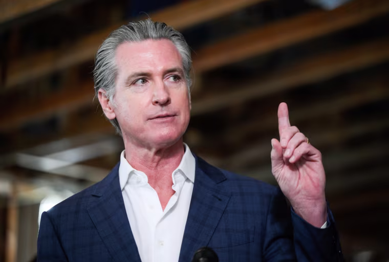 Governor Newsom speaks while pointing his finger upwards