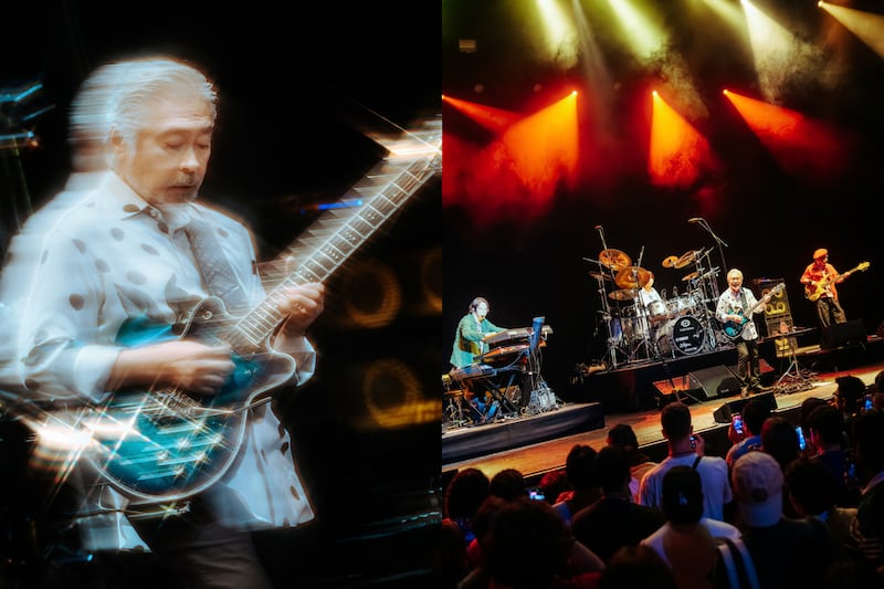 Guitarist and band playing on stage