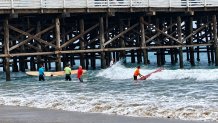 Surfers prepare to compete, Saturday, making their way out to the surf, September 12, 2026.