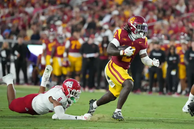 Sep 4, 2026; Los Angeles, California, USA; Southern California Trojans running back Waymond Jordan (2) carries the ball against Fresno State Bulldogs defensive lineman Jahzon Jacks (6) in the first half at United Airlines Field at Los Angeles Memorial Coliseum. Mandatory Credit: Kirby Lee-Imagn Images