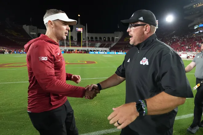 Sep 4, 2026; Los Angeles, California, USA; Southern California Trojans head coach Lincoln Riley (left) and Fresno State Bulldogs head coach Matt Entz shake hands after the game at United Airlines Field at Los Angeles Memorial Coliseum. Mandatory Credit: Kirby Lee-Imagn Images