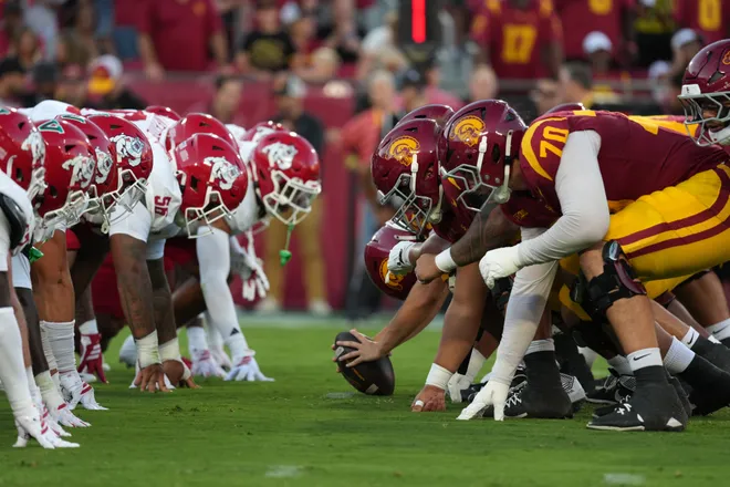 Sep 4, 2026; Los Angeles, California, USA; Helmets at the line of scrimmage as Southern California Trojans long snapper Luke Brown (53) snaps the ball against the Fresno State Bulldogs in the first half at United Airlines Field at Los Angeles Memorial Coliseum. Mandatory Credit: Kirby Lee-Imagn Images
