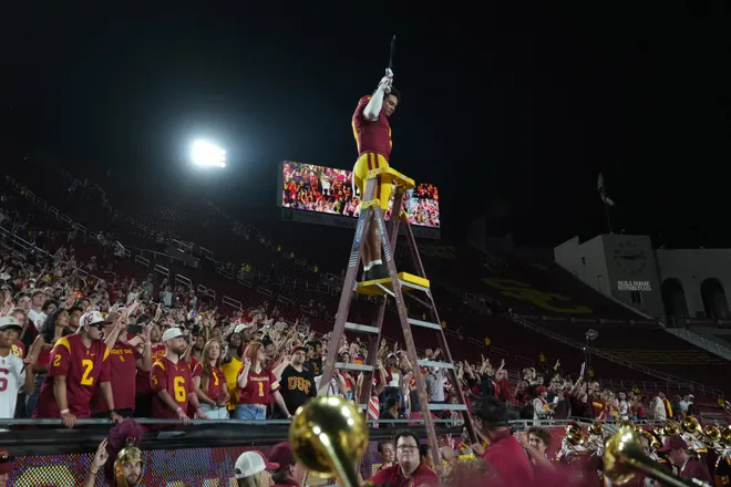 Sep 4, 2026; Los Angeles, California, USA; Southern California Trojans safety Kennedy Urlacher (9) leads the Spirit of Troy marching band to a rendition of Tribute to Troy after the game against the Fresno State Bulldogs at United Airlines Field at Los Angeles Memorial Coliseum. Mandatory Credit: Kirby Lee-Imagn Images
