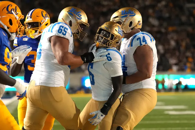 Sep 5, 2026; Berkeley, California, USA; UCLA Bruins running back Anthony Woods (6) celebrates with offensive linemen Hall Schmidt (65) and Julian Armella (74) after scoring a touchdown against the California Golden Bears during the second quarter at California Memorial Stadium. Mandatory Credit: Darren Yamashita-Imagn Images
