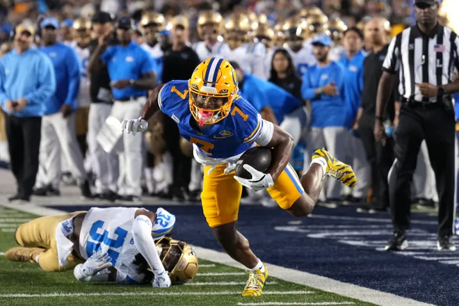 Sep 5, 2026; Berkeley, California, USA; California Golden Bears wide receiver Chase Hendricks (7) eludes the tackle attempt by UCLA Bruins defensive back Derrick Barksdale (left) to score a touchdown during the first quarter at California Memorial Stadium. Mandatory Credit: Darren Yamashita-Imagn Images