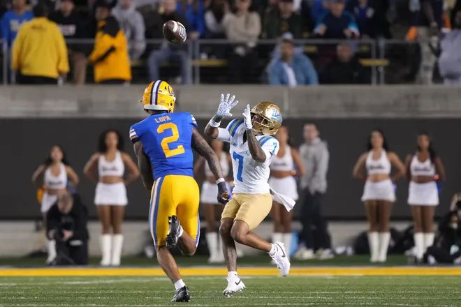 Sep 5, 2026; Berkeley, California, USA; UCLA Bruins wide receiver Mikey Matthews (7) catches a pass against California Golden Bears defensive back Kingston Lopa (2) during the second quarter at California Memorial Stadium. Mandatory Credit: Darren Yamashita-Imagn Images