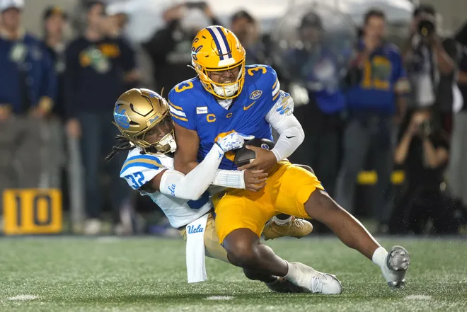 Sep 5, 2026; Berkeley, California, USA; UCLA Bruins defensive back Derrick Barksdale (32) sacks California Golden Bears quarterback Jaron-Keawe Sagapolutele (3) during the second quarter at California Memorial Stadium. Mandatory Credit: Darren Yamashita-Imagn Images
