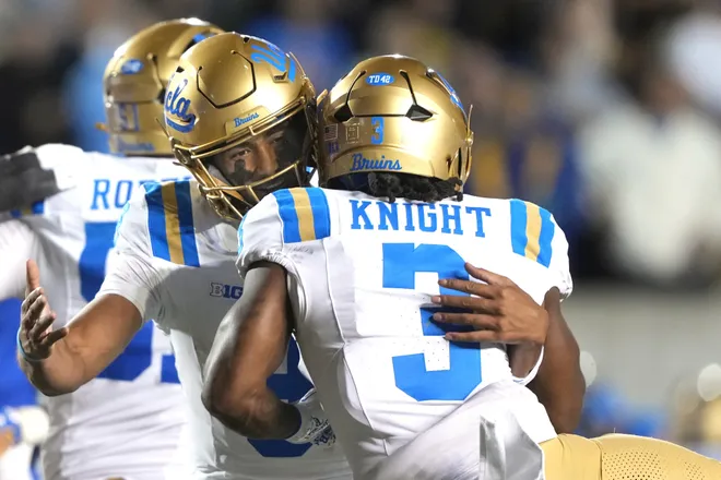 Sep 5, 2026; Berkeley, California, USA; UCLA Bruins running back Wayne Knight (3) is congratulated by quarterback Nico Iamaleava (center left) after scoring a touchdown against the California Golden Bears during the fourth quarter at California Memorial Stadium. Mandatory Credit: Darren Yamashita-Imagn Images