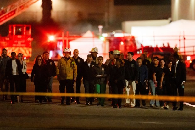 Los Angeles Mayor Karen Bass joined by other officials walk to a news conference near the scene of a helicopter crash in Chatsworth, a neighborhood in Los Angeles, Tuesday, Sept. 15, 2026. (AP Photo/Ethan Swope)