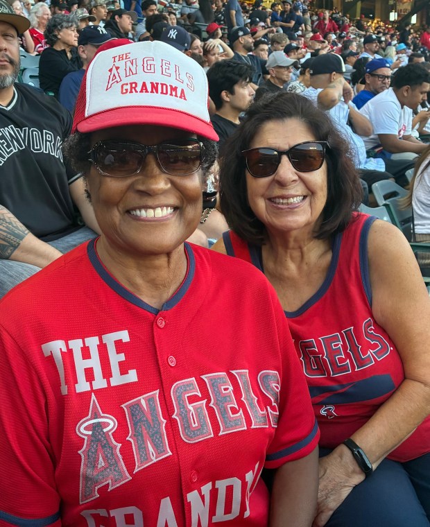 Cynthia Johnson, left, and Sylvia Castro pose for a photo during the Angels' game against the New York Yankees on Tuesday night at Angel Stadium. Johnson, known on social media as "The Angels Grandma" was thrilled by Tuesday's news that Angels owner Arte Moreno is selling the team to Rams owner Stan Kroenke. (Photo by Steve Fryer, The Orange County Register/SCNG)