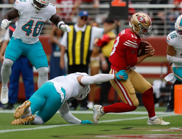 San Francisco 49ers starting quarterback Brock Purdy (13) scores a touchdown against Miami Dolphins' Jacob Rodriguez (10) in the second quarter at Levi's Stadium in Santa Clara, Calif., on Sunday, Sept. 20, 2026. (Nhat V. Meyer/Bay Area News Group)