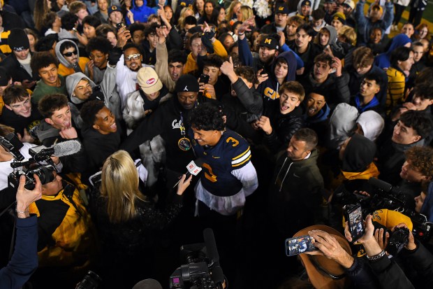 ESPN sideline reporter Lauren Sisler speaks to California Golden Bears quarterback Jaron-Keawe Sagapolutele (3) after their game at Memorial Stadium in Berkeley, Calif., on Saturday, Nov. 29, 2025. The California Golden Bears defeated the Southern Methodist Mustangs 38-35. (Jose Carlos Fajardo/Bay Area News Group)