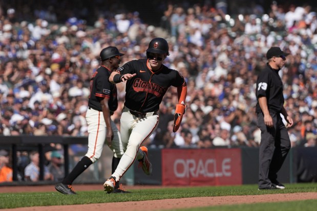 San Francisco Giants' Drew Gilbert runs home to score against the Los Angeles Dodgers during the seventh inning of a baseball game, Saturday, Sept. 26, 2026, in San Francisco. (AP Photo/Jeff Chiu)