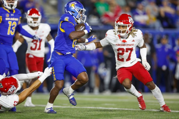 San Jose State Spartans' Jabari Bates (6) runs with the ball against Fresno State Bulldogs' Camrin Cole (13) and Fresno State Bulldogs' Gerayas Grimes (27) in the second quarter at CEFCU Stadium in San Jose, Calif., on Saturday, Sept. 19, 2026. (Shae Hammond/Bay Area News Group)
