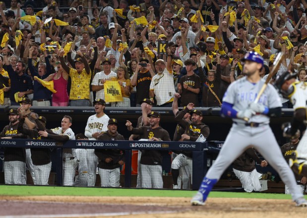 The Padres dugout and fans celebrate their win as Cubs pinch hitter Michael Conforto strikes out to end the ninth inning in Game 1 of their wild-card series on Sept. 29, 2026, in San Diego. (Brian Cassella/Chicago Tribune)