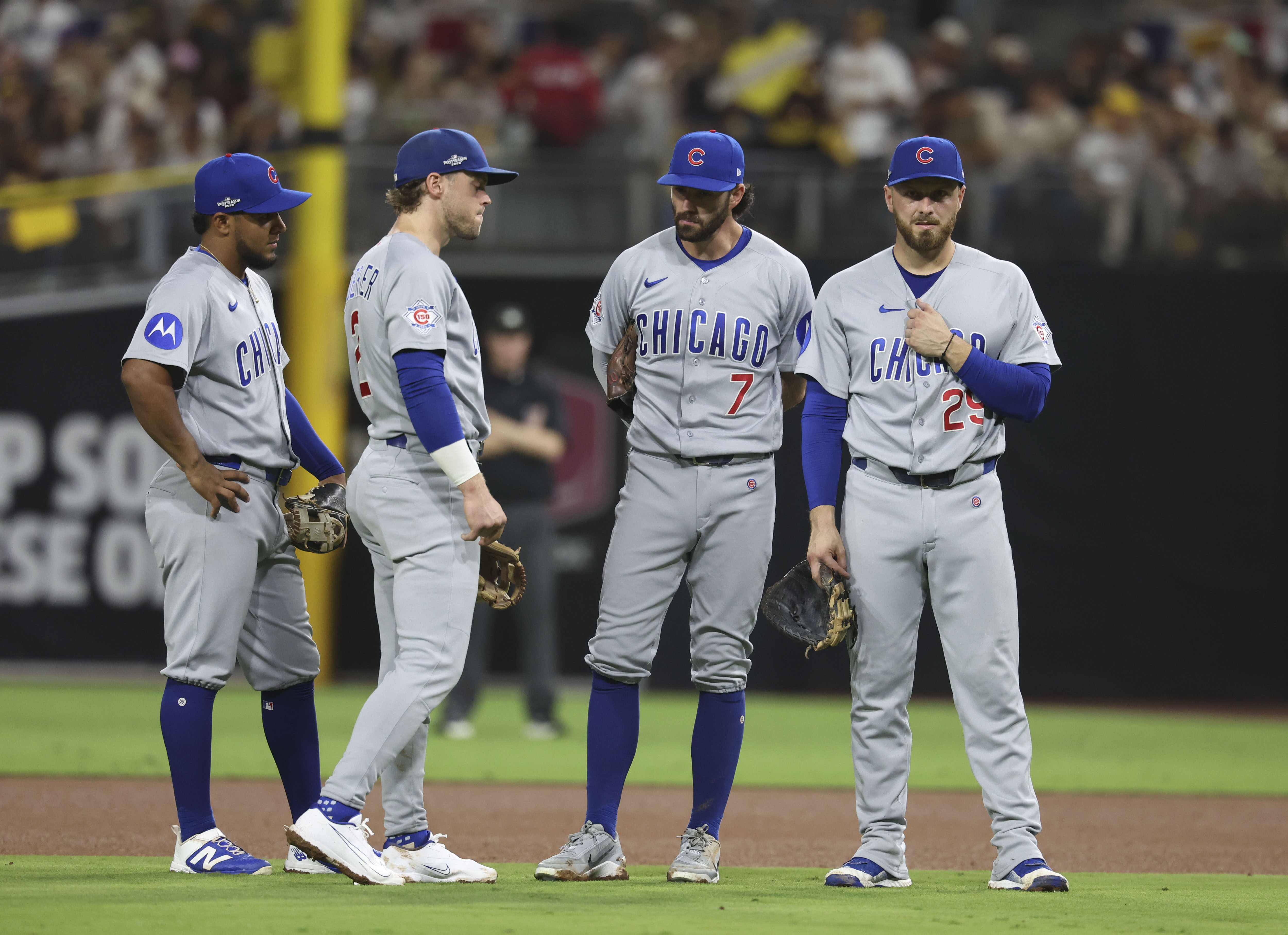 Cubs infielders Pedro Ramírez, left to right, Nico Hoerner, Dansby Swanson and Michael Busch react during a pitching change against the Padres in the sixth inning in Game 1 of their wild-card series on Sept. 29, 2026, in San Diego. (Brian Cassella/Chicago Tribune)