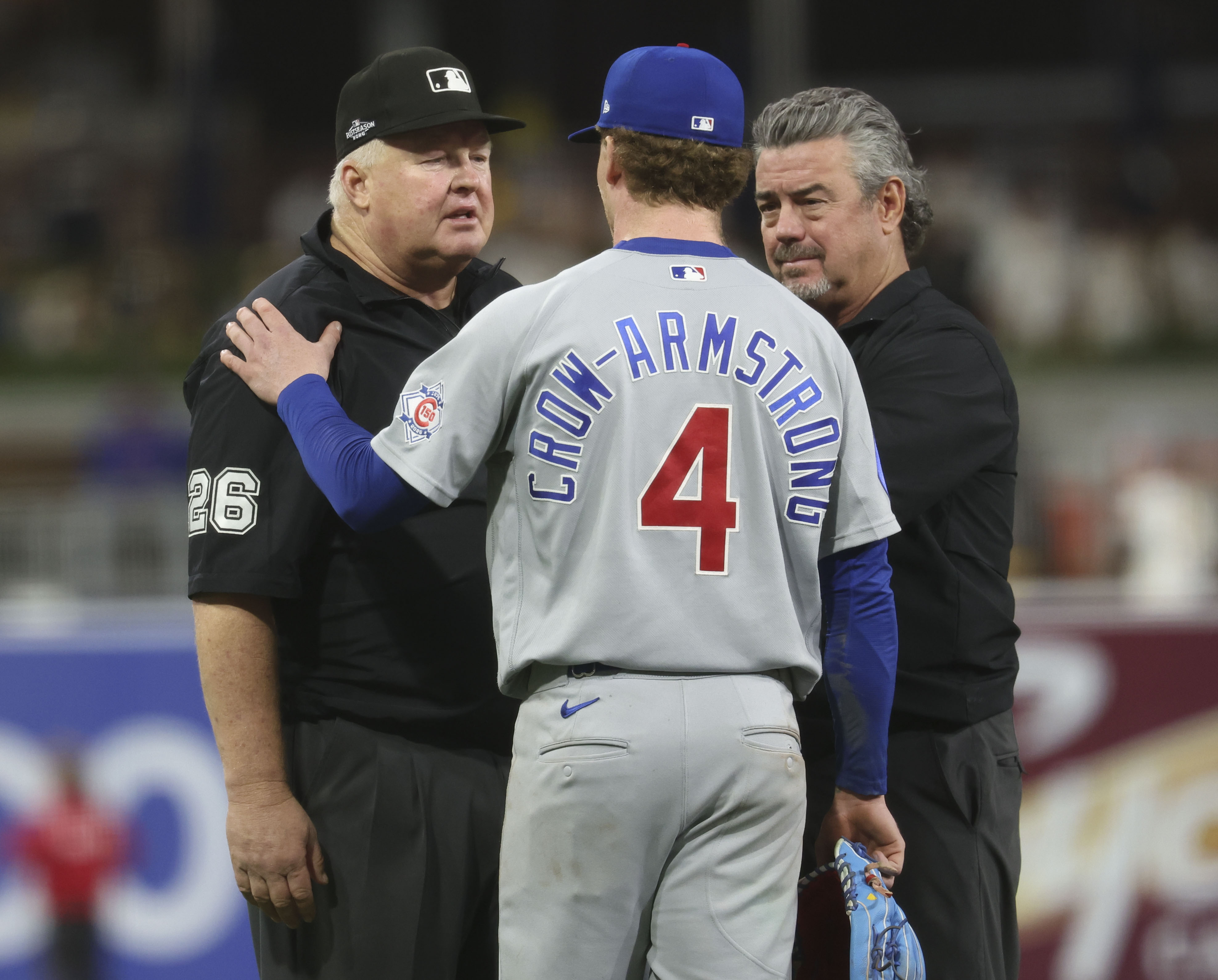 Cubs center fielder Pete Crow-Armstrong talks to umpire Bill Miller (26) after being called for a third strike swinging in the eighth inning against the Padres in Game 1 of their wild-card series on Sept. 29, 2026, in San Diego. (Brian Cassella/Chicago Tribune)