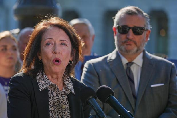 Sen. Maria Cantwell, D-Wash., left, speaks as Sen. Ted Cruz, R-Texas, right, listens.