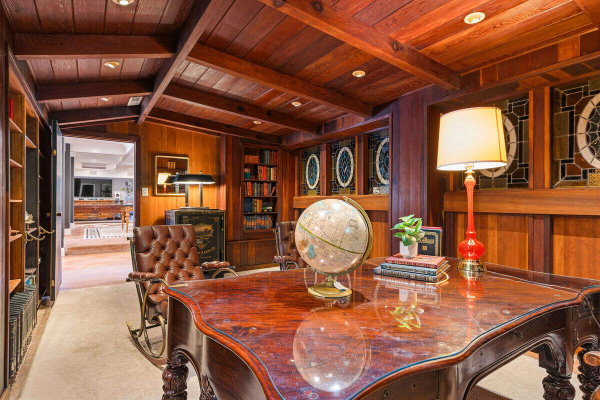 A private office off the home’s downstairs entertainment room provides a quiet workspace within the riverfront estate. The lower level also includes a bar, wine cellar, game area and media lounge.