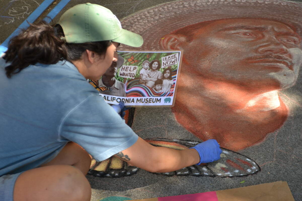 Mariah Quintanilla illustrates the sidewalks around Fremont Park at the annual “Chalk It Up” chalk art and music festival Saturday in Sacramento.