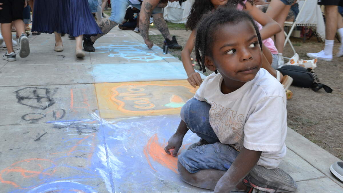 Sunny Brice, 4, works on an original chalk art piece at the annual “Chalk It Up” chalk art and music festival Saturday at Fremont Park in Sacramento.