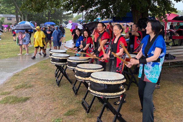 A drum team from the community entertained spectators who weathered the rain that fell Sunday during the 17th Annual Dragon on the Lake Dragon Boat Races. (Gina Joseph, for The Oakland Press)