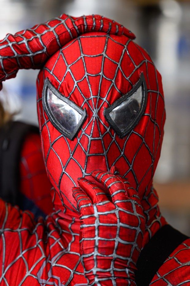 A cosplayer dressed as Spider-Man adjusts their mask while attending the fourth annual Cape & Cowl Con held at Faction Brewing in Alameda, Calif., on Sunday, Aug. 30, 2026. The event is hosted by Oakland's Cape & Cowl Comics with 150 vendors, authors and artist attending. (Jose Carlos Fajardo/Bay Area News Group)