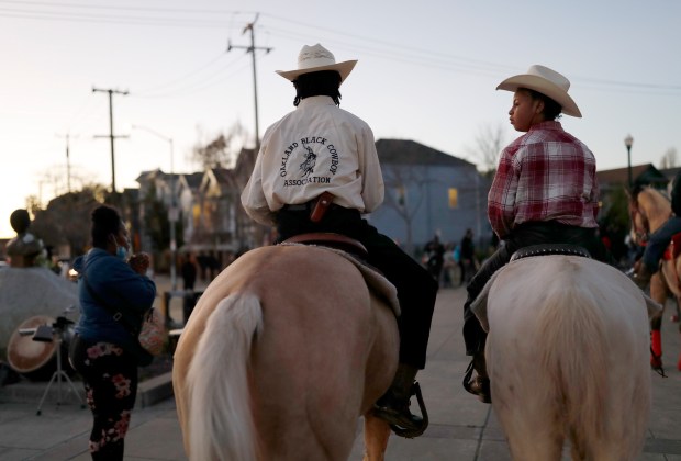 An Oakland Black Cowboy Association member and his daughter listen to speakers during Black Solidarity Week in Oakland in 2022. (Jane Tyska/Bay Area News Group)