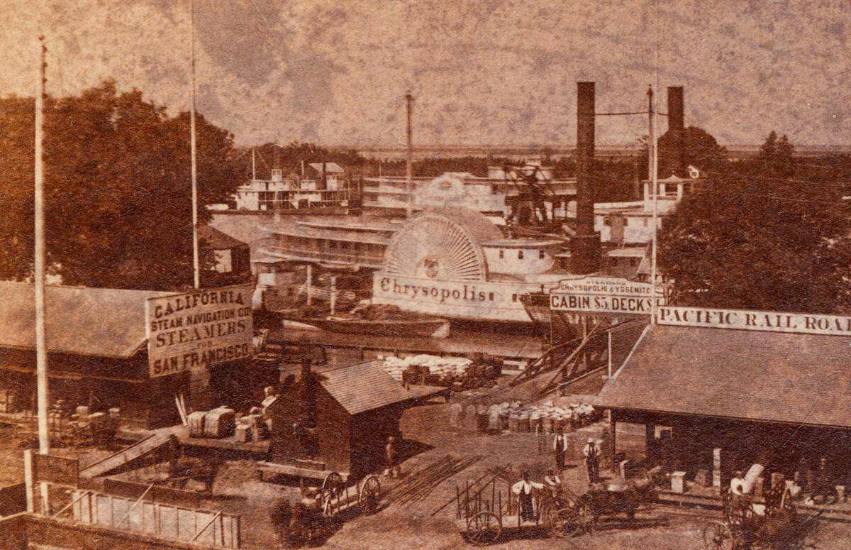 The steamboat Chrysopolis is docked at the California Steam Navigation Company’s landing area on the Sacramento waterfront in an 1860s image from the Central Pacific Railroad Company, which had a depot at right.