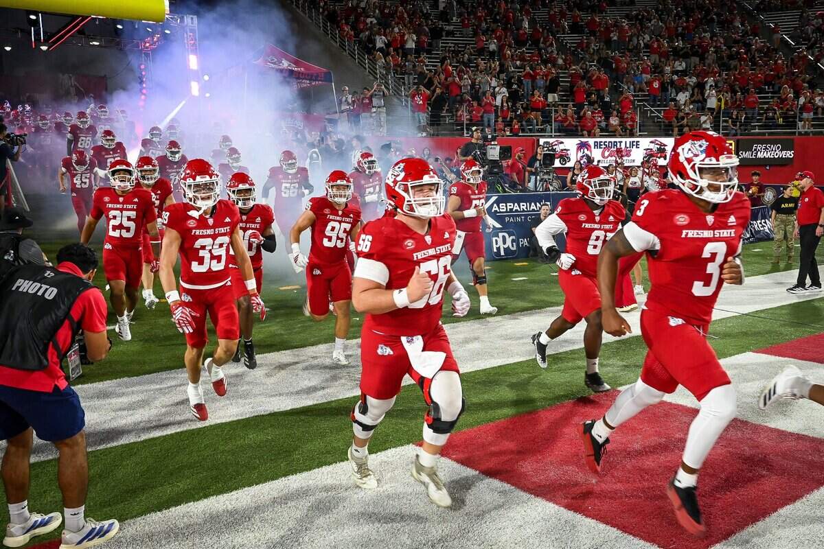Fresno State players run onto the field before the start of their first home game of the year against Sacramento State at Valley Children's Stadium in Fresno on Saturday, Sept. 12, 2026.