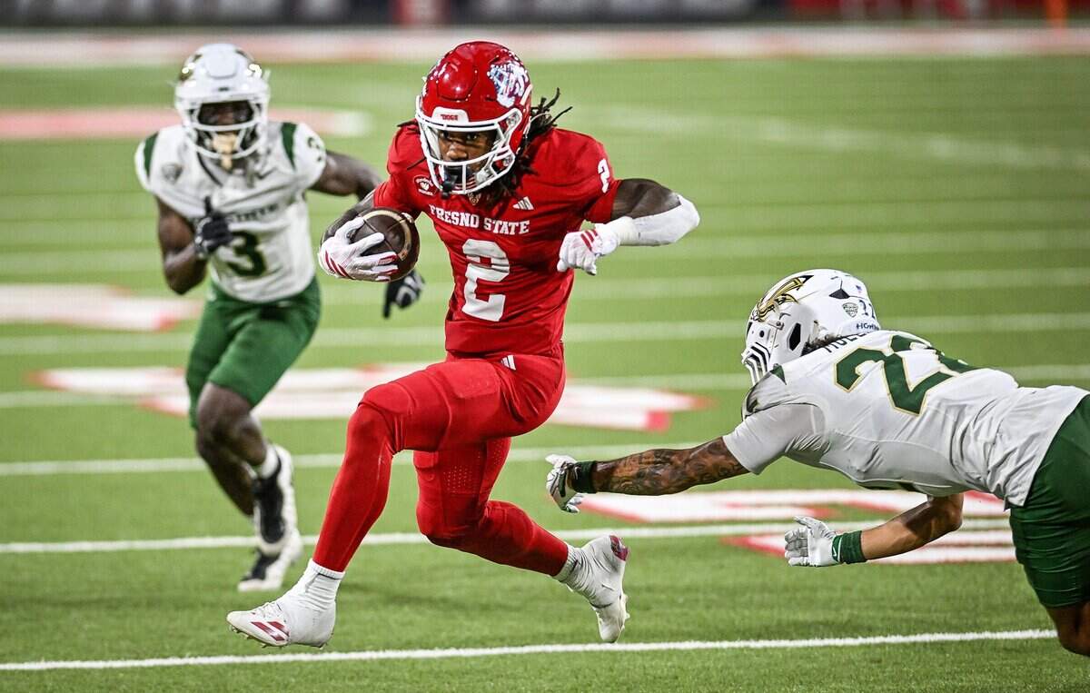 Fresno State's Rayshon Luke leaps away from Sacramento State's Elias Mullican on his way to a touchdown after a catch down the middle during their game at Valley Children's Stadium in Fresno on Saturday, Sept. 12, 2026.