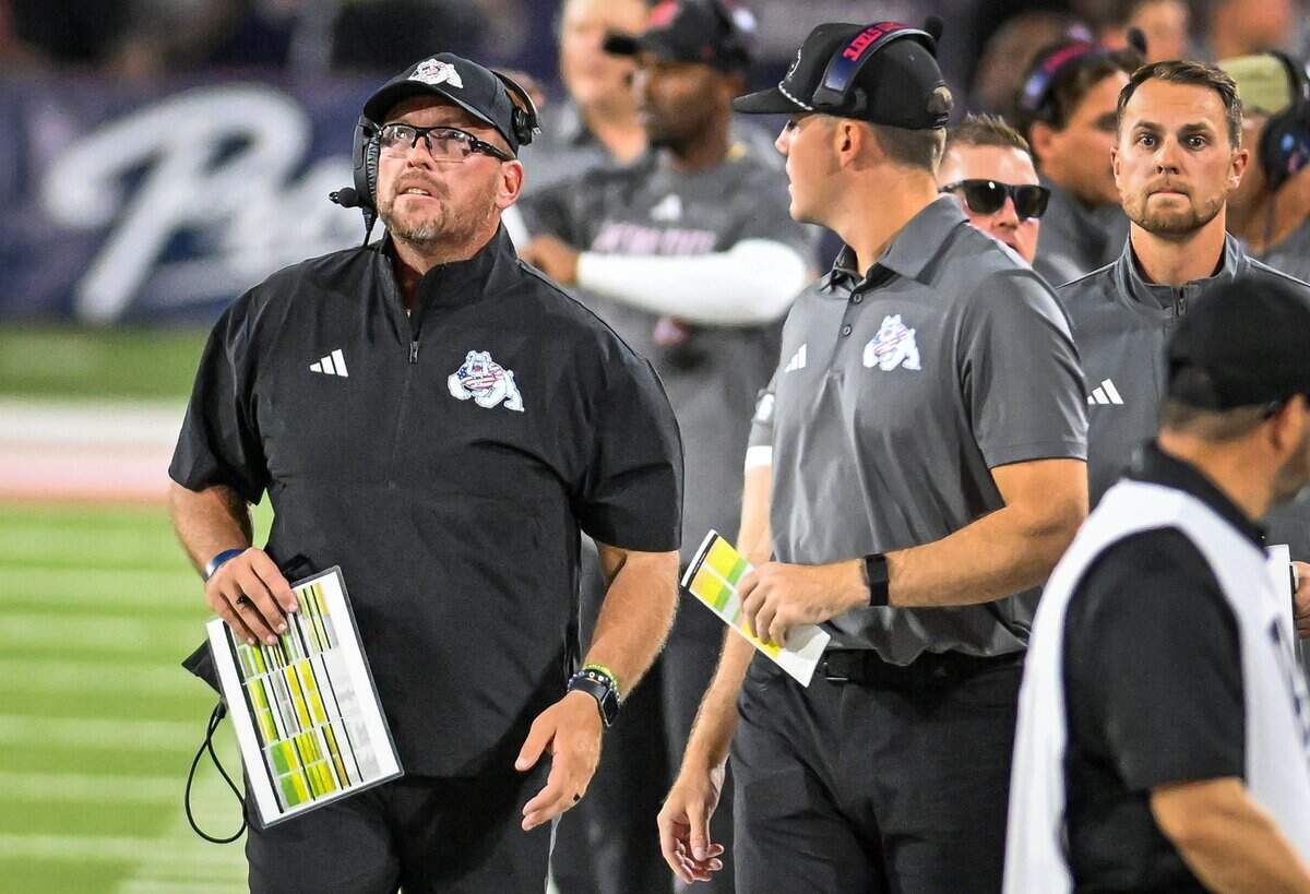 Fresno State head football coach Matt Entz, left, looks up at the scoreboard during the Bulldogs game against Sacramento State at Valley Children's Stadium in Fresno on Saturday, Sept. 12, 2026.