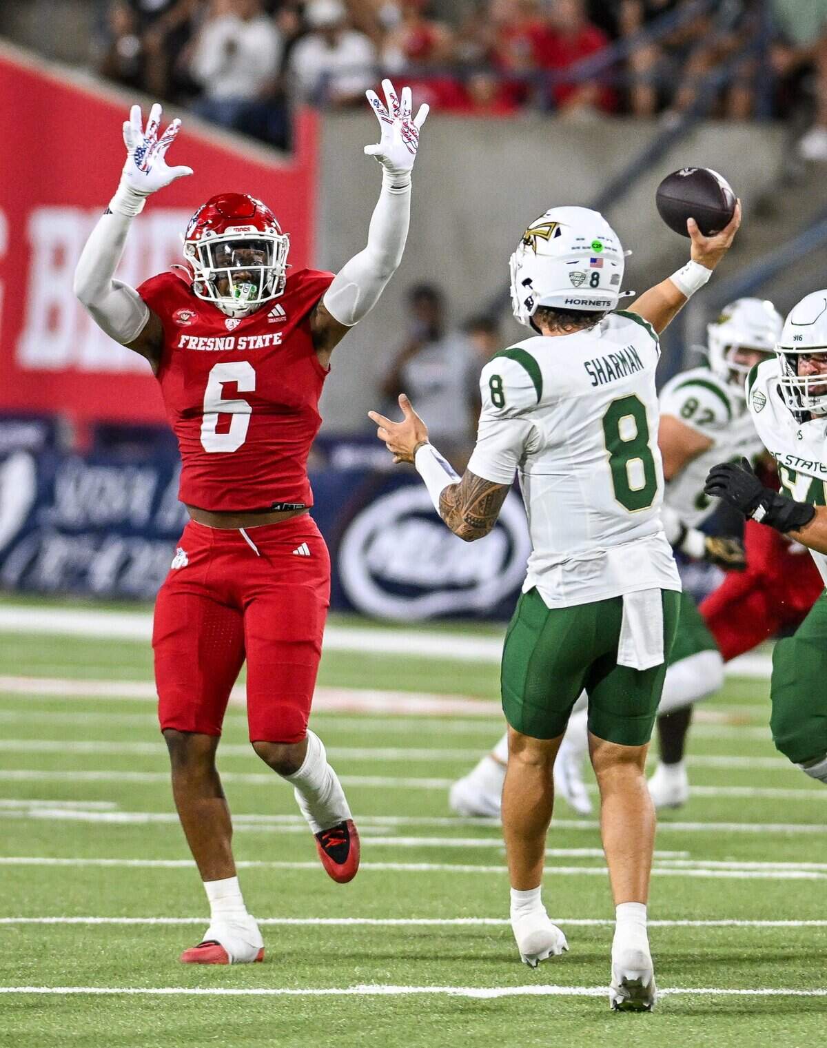 Fresno State's Jahzon Jacks, left, puts his hands up as Sacramento State quarterback Jackson Sharman throws during their game at Valley Children's Stadium in Fresno on Saturday, Sept. 12, 2026.