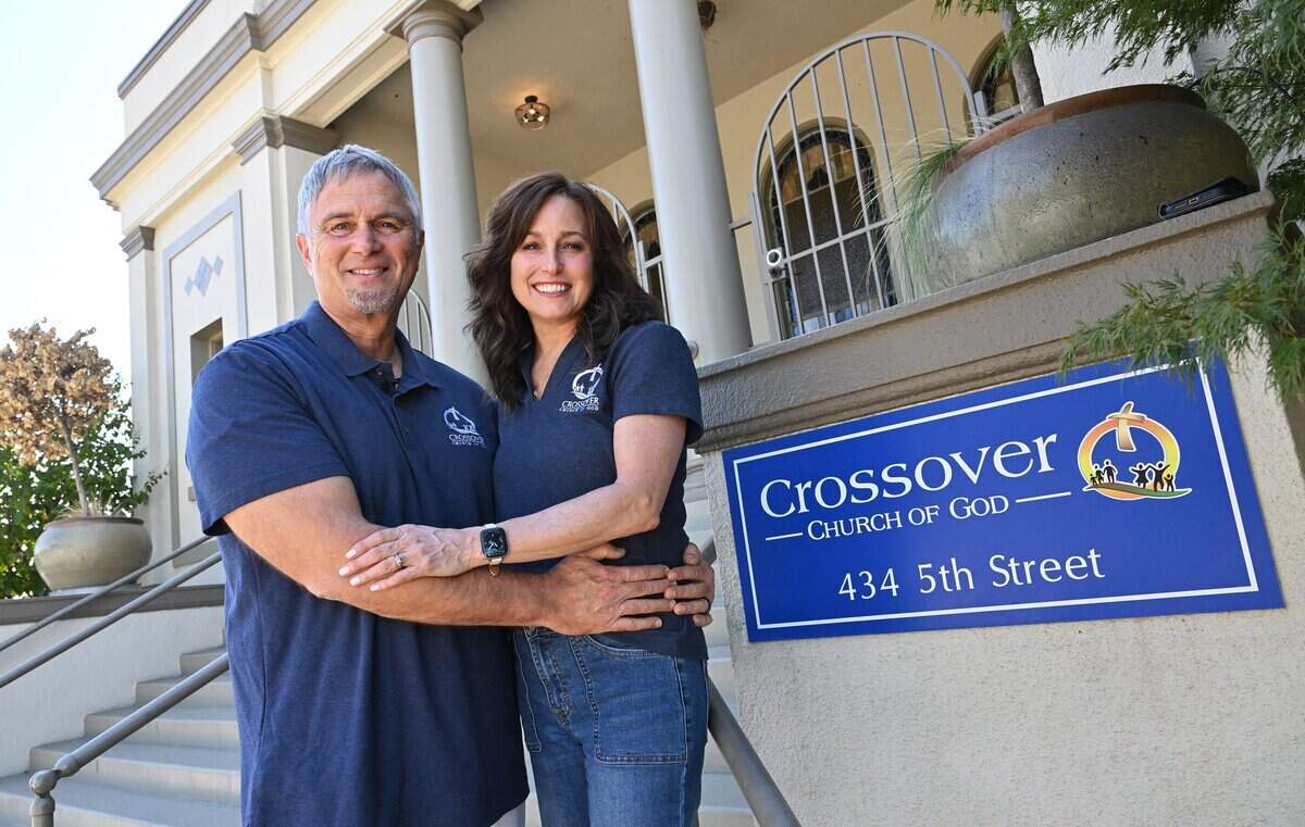 Crossover Church of God pastor Chris May, with his wife DeeDee May, Women's Ministry Leader, stand in front of the century-old church they lead, Wednesday, Sept. 9, 2026 in Clovis.