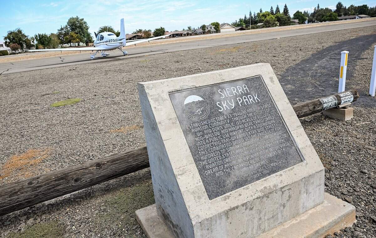 A monument near the airstrip at Sierra Sky Park in northwest Fresno gives information about the spot being described as the world's first residential fly-in aviation community. Photographed on Tuesday, Sept. 8, 2026.