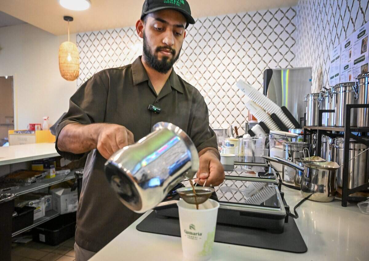 Nagi Alazani prepares a cup of Yemeni coffee at Qamaria Yemeni Coffee Co., which he recently opened in the Marketplace at El Paseo with partner Shehab Zanzam.